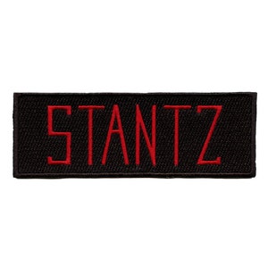 May include: Black fabric patch with the word "STANTZ" embroidered in red.