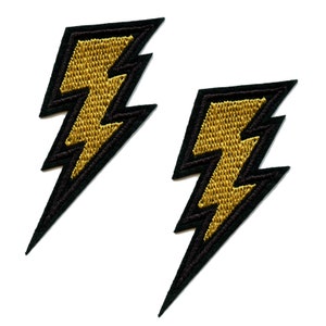 May include: Two black and gold lightning bolt iron-on patches. The patches are embroidered with a gold lightning bolt design on a black background.