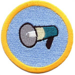 May include: A blue and yellow embroidered patch with a gray megaphone with a white stripe and teal and white stripes on the megaphone.