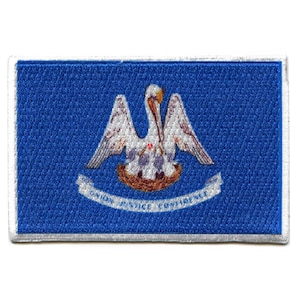 May include: Embroidered patch featuring the state flag of Louisiana. The patch is blue with a white pelican in a nest, and the words "Union Justice Confidence" are written on a white ribbon.