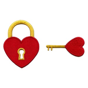 May include: A red heart-shaped padlock with a gold outline and keyhole, and a matching red heart-shaped key with a gold outline.