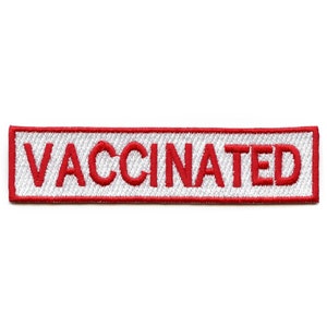 Peut inclure: Un patch rectangulaire blanc avec une bordure brodée rouge et le mot "VACCINÉ" en rouge.