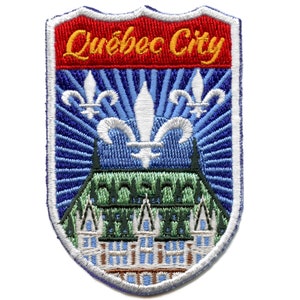 May include: Embroidered patch featuring a blue and white shield with a stylized image of the Chateau Frontenac in Quebec City, Canada. The text "Quebec City" is in yellow on a red banner at the top of the shield.