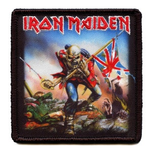 May include: Iron Maiden band patch with a black background and a colorful image of a soldier holding a flag. The text "Iron Maiden" is printed in white letters at the top of the patch.