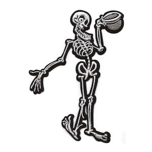 May include: Embroidered patch featuring a black and white skeleton holding a cup. The skeleton is depicted in a whimsical pose, with detailed bone structure and a black border. Ideal for jackets, bags, or other fabric items.