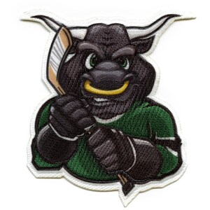 May include: An embroidered patch featuring a cartoon bull mascot wearing a green and white hockey jersey and holding a hockey stick. The bull has a black face with a yellow mouth and green eyes.