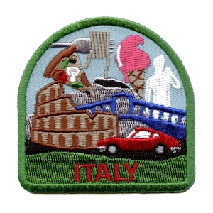 May include: Embroidered patch with a green border and a blue sky background. The patch features a red car, a blue bridge, a brown building, a pizza slice, a pink ice cream cone, and a white stick figure. The text "ITALY" is written in red at the bottom of the patch.