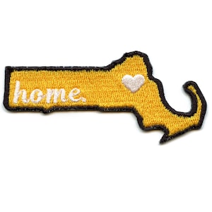 May include: Yellow felt outline of the state of Massachusetts with the word "home" embroidered in white and a white heart in the upper right corner.