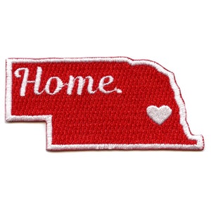 May include: Red embroidered patch shaped like the state of Nebraska with white outline. The patch says "Home" in white cursive lettering and has a white heart in the lower right corner.
