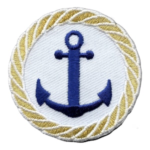 May include: Round patch with a navy blue anchor on a white backdrop, framed by a gold rope border. This nautical-themed patch is designed for application on clothing or accessories. The patch has a textured surface.