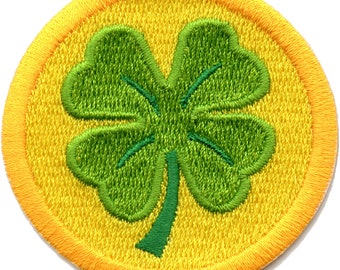 May include: A green four-leaf clover embroidered on a yellow circle patch.