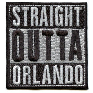 May include: Embroidered patch with the words "STRAIGHT OUTTA ORLANDO" in white thread on a black and gray background. The patch has a square shape with a black border.