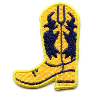 Könnte beinhalten: Gelber, gestickter Aufnäher in Form eines Cowboy-Stiefels. Der Stiefel hat ein dunkelblaues Design aus zwei stilisierten Figuren. Der Stiefel hat eine dunkelblaue Umrandung und Nähte.