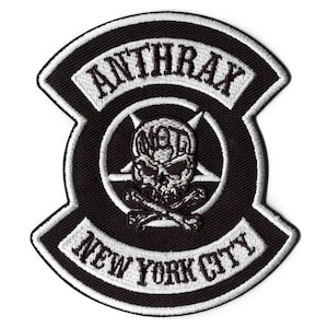 May include: Black and white embroidered patch with a skull and crossbones design. The patch features the text "Anthrax" and "New York City".