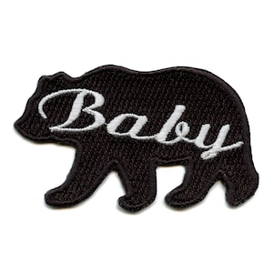 May include: Black embroidered iron-on patch of a bear silhouette with the word "Baby" in white cursive lettering.