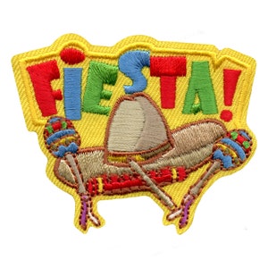 May include: A yellow embroidered patch with the word "FIESTA!" in colorful letters. The patch features a sombrero, maracas, and a festive design.