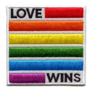 May include: A white patch with a rainbow stripe design and the words "LOVE WINS" in black.