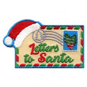 May include: A red and white Santa hat on top of a yellow envelope with a green and red holly stamp. The envelope says "Letters to Santa" in green and red letters.
