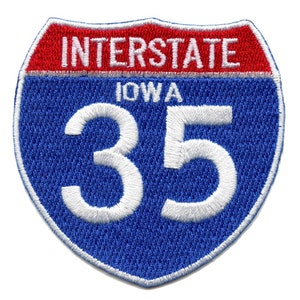 May include: Blue and red interstate highway sign with white text. The sign reads "INTERSTATE IOWA 35".