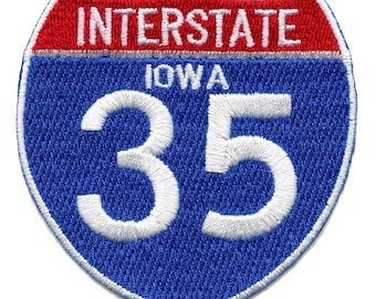 May include: Blue and red interstate highway sign with white text. The sign reads "INTERSTATE IOWA 35".