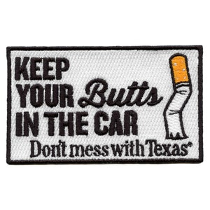 May include: White embroidered patch with black text that reads "Keep Your Butts in the Car Don't mess with Texas" and a white cigarette with an orange filter.