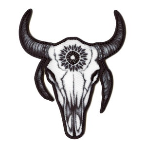 May include: Black and white embroidered patch of a bull skull with a mandala design in the center.