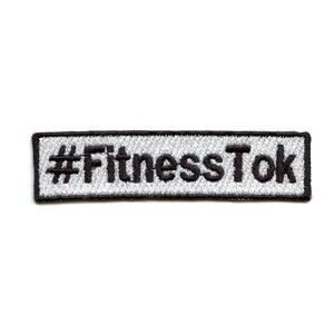 May include: A white and gray embroidered patch with black text that reads "#FitnessTok".