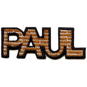 May include: Brown and white embroidered iron-on patch with the word "PAUL" in a brick pattern.