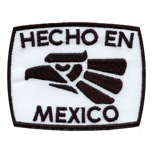 May include: White rectangular patch with brown embroidered text "HECHO EN MEXICO" and a stylised brown eagle design.