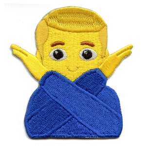 May include: Yellow embroidered patch of a cartoon character with blonde hair, wearing a blue robe, with arms outstretched.