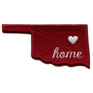 May include: Red embroidered patch shaped like the state of Oklahoma with a white heart and the word "home" in white cursive lettering.