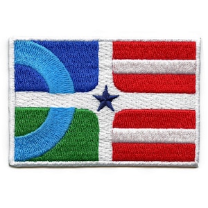 May include: Embroidered patch featuring a stylized flag design with a blue, green, and white geometric pattern on the left side and a red and white striped pattern on the right side. A blue five-pointed star is in the center of the patch.