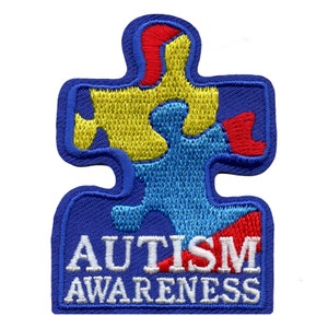 May include: Blue puzzle piece with yellow, red, and light blue sections. The text "AUTISM AWARENESS" is written in white letters below the puzzle piece.