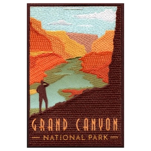 May include: Embroidered patch featuring a scenic view of the Grand Canyon with a silhouette of a person looking out over the canyon. The text "Grand Canyon National Park" is below the image.