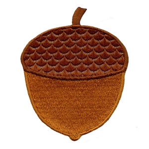May include: A brown felt acorn patch with a textured top and a smooth bottom.