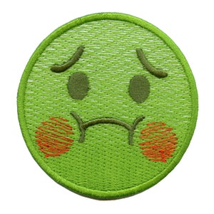 May include: Green embroidered patch with a sad face emoji. The face has red cheeks and a frown.