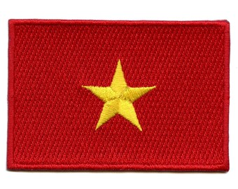 May include: An embroidered patch featuring a red background with a yellow five-pointed star in the centre. This patch represents the flag of Vietnam.