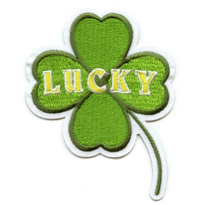 May include: Embroidered green four-leaf clover patch with the word "LUCKY" in yellow letters. The clover has a white border and a stem. Ideal for St. Patrick's Day or adding a touch of luck to clothing or accessories.