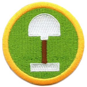 May include: A green and yellow embroidered patch with a white shovel and brown handle.