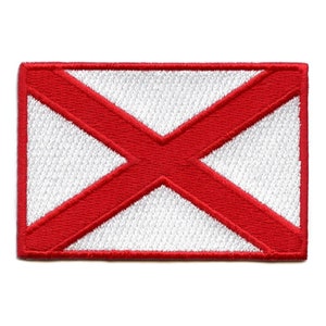May include: Embroidered patch featuring the Alabama state flag. The rectangular patch has a white background with a prominent red X shape crossing the center. The border and the X are in a vibrant red color.
