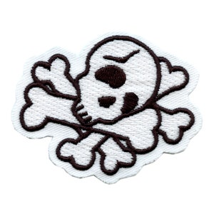 May include: White embroidered skull and crossbones patch with brown stitching. The skull has a frowning expression and one eye.