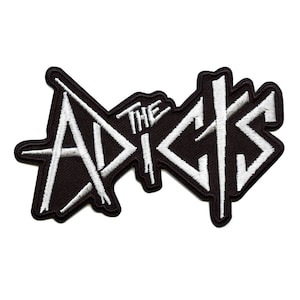 May include: Embroidered patch with the words "THE ADDICTS" in white, bold lettering on a black background. The patch has a black border and is designed for application to clothing or accessories.