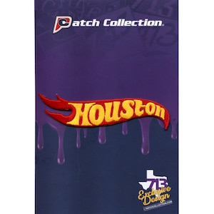 May include: Red and yellow embroidered patch with the word "HOUSTON" in a stylized font, resembling a Hot Wheels logo. The patch is on a purple background with a dripping effect.