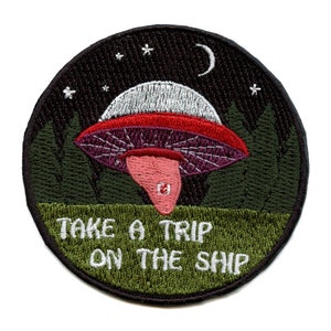 May include: Embroidered patch featuring a cartoon UFO flying over a forest at night. The text "Take a trip on the ship" is written below the UFO.