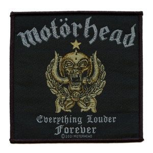 May include: Black woven patch with the band name "Motörhead" in white lettering, a gold skull with wings, and the text "Everything Louder Forever" in white lettering. The patch has a brown border.