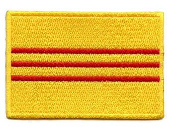 May include: Yellow fabric patch with three red horizontal stripes.