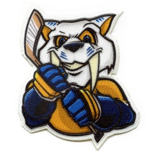 May include: A white, blue, and yellow embroidered patch of a cartoon saber-toothed tiger holding a hockey stick. The tiger has a fierce expression and large, sharp teeth.