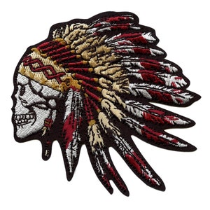 May include: Embroidered iron-on patch featuring a skull wearing a red, white, and gold headdress with feathers.