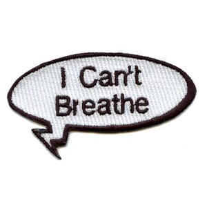 May include: White embroidered patch with a black outline in the shape of a speech bubble. The text inside the speech bubble reads "I Can't Breathe".