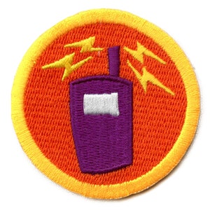 Könnte beinhalten: Ein runder, orangefarbener und gelber gestickter Aufnäher mit einem violetten Walkie-Talkie und Blitzen.